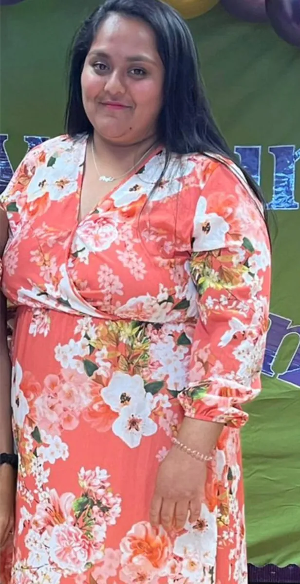 Pooja before coaching, in a floral dress